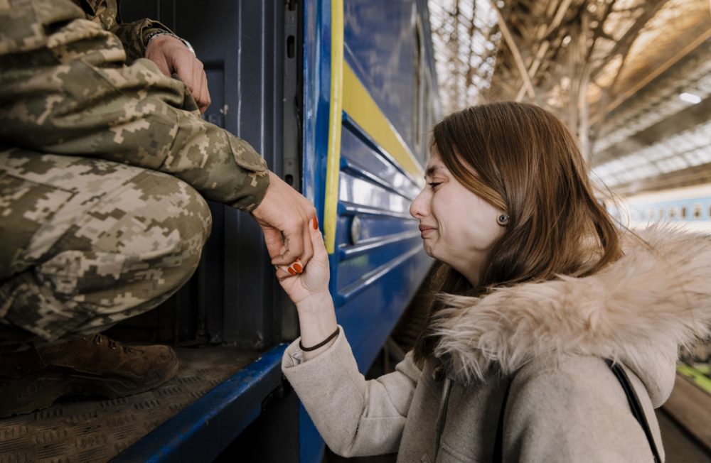 LVIV, UKRAINE - 15TH OF MARCH, 2022:  
Soldier Volodimir (20, l) and his girlfriend Tanya (21) while saying goodbye at the trainstation in Lviv, Ukraine on March 15th 2022. He departs to Kramatorsk, to fight in the war that started after Russia invading Ukraine on the 24th of February 2022. CREDIT: Ilvy Njiokiktjien