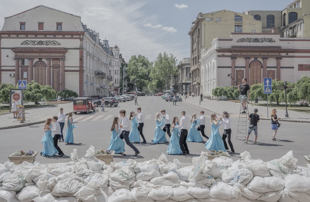 Odesa I Ukraine I 15.06.2022 
In June 2022, amidst restrictions on gatherings due to war, young Ukrainian graduates created a powerful art performance by dancing in front of sandbags at the opera theater. They shared it on social media to showcase their losses and resilience to the world. In this display of unity, they stood defiantly, symbolically turning the barricades of sandbags into a canvas of expression.